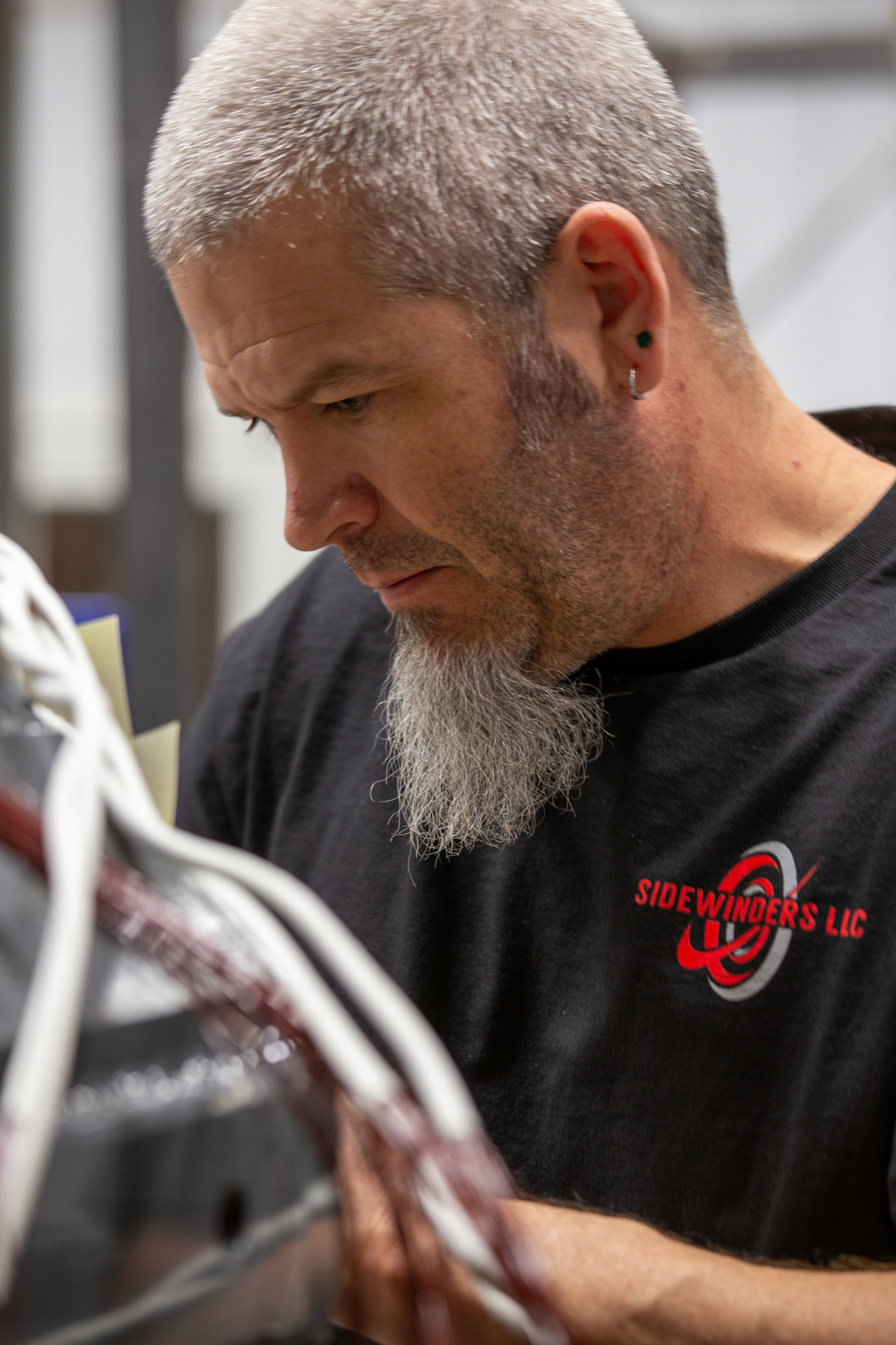 Close-up of a Sidewinders winder examining coil insulation