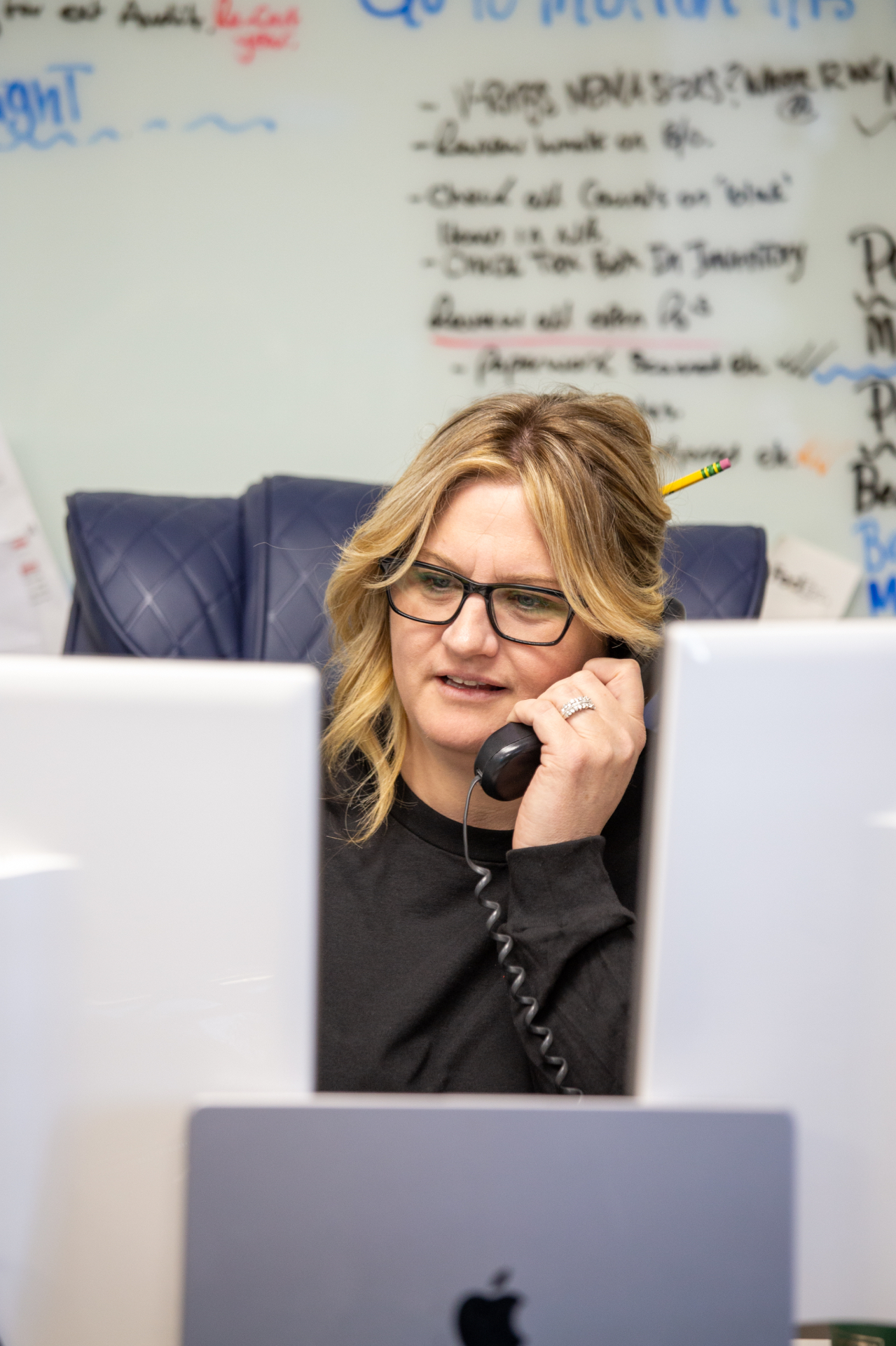 Sidewinders operations coordinator at her desk handling a job intake